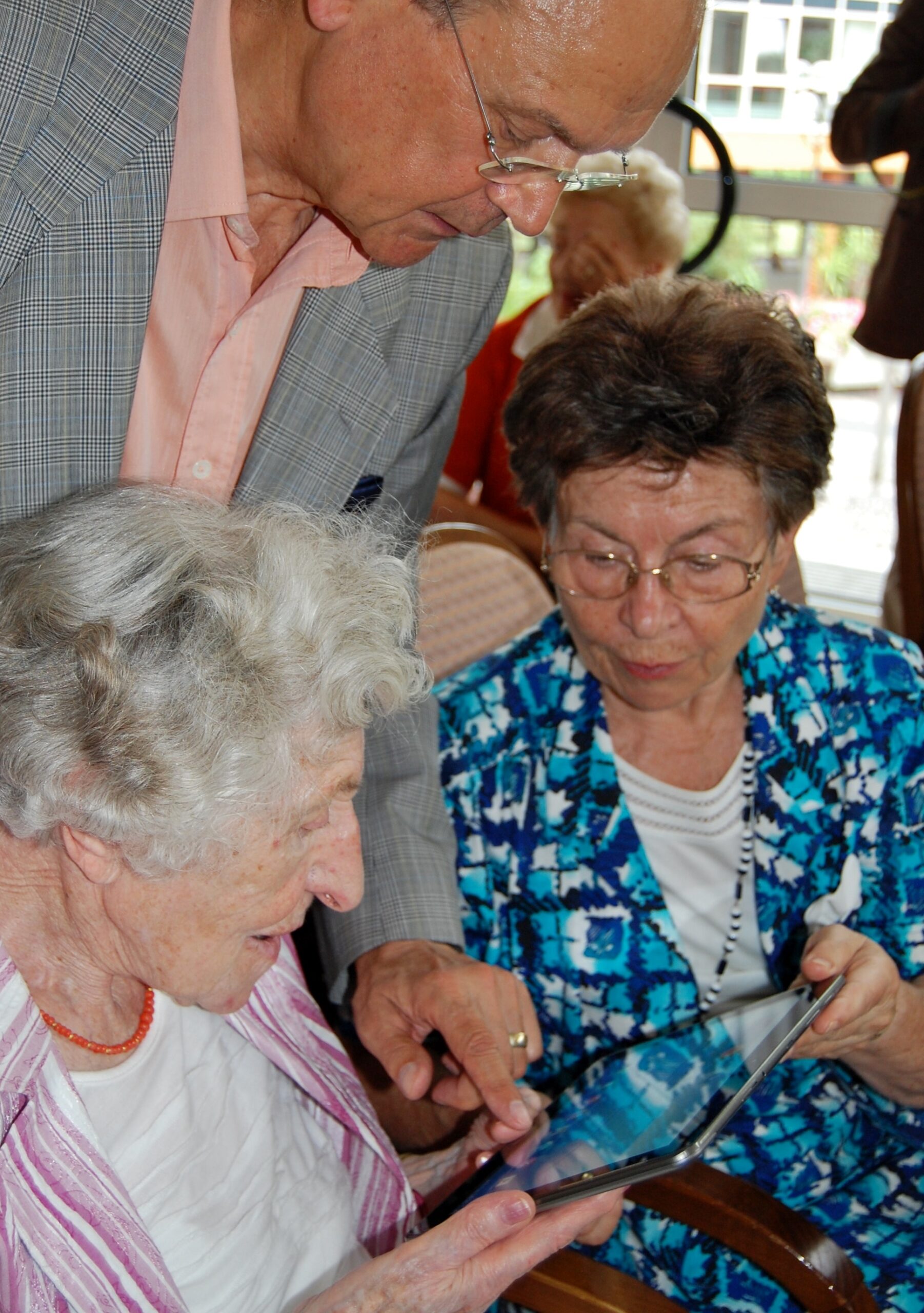 Older adults using a tablet Older adults sit together using a tablet, a common moment for a fake tech-support pop-up to appear.